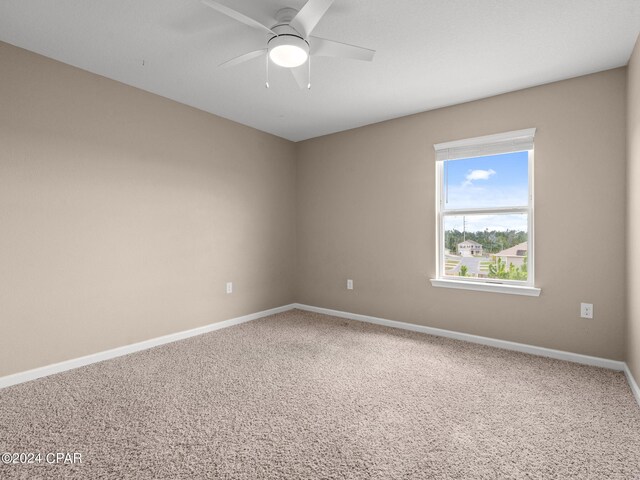 unfurnished room with ceiling fan and carpet flooring