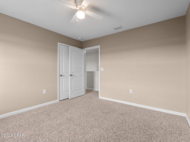 unfurnished bedroom featuring ceiling fan and carpet flooring