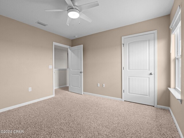 unfurnished bedroom with carpet and ceiling fan