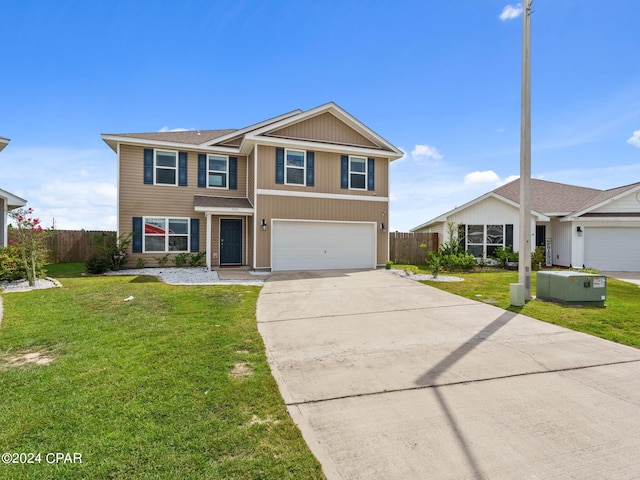 view of front of house featuring a garage and a front lawn