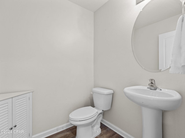 bathroom featuring hardwood / wood-style floors, toilet, and sink