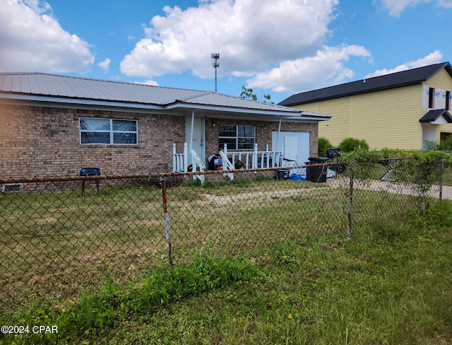 rear view of property featuring a lawn