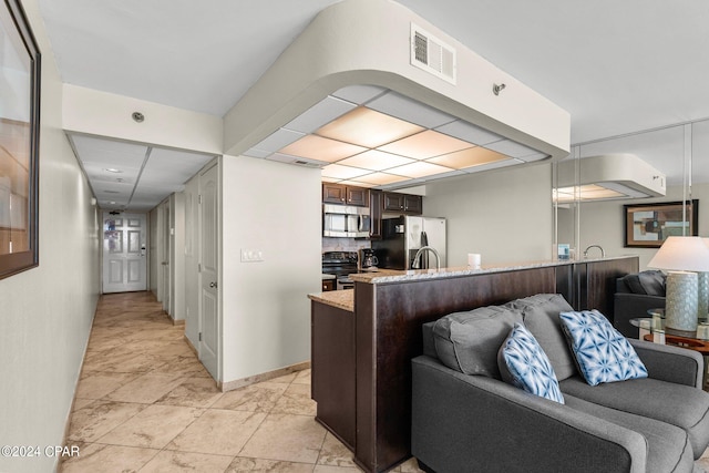 tiled living room featuring sink