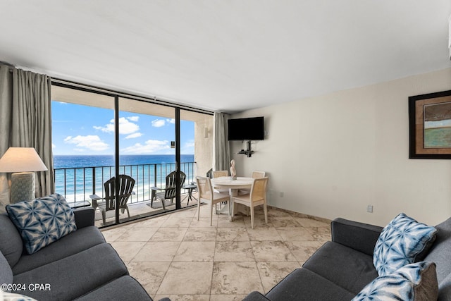 living room featuring expansive windows and light tile patterned floors