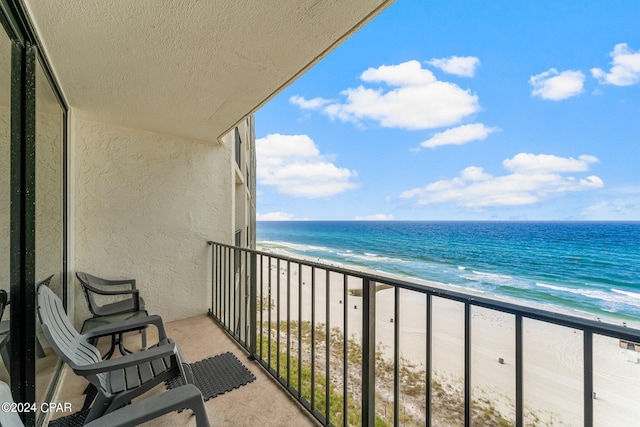 balcony with a beach view and a water view