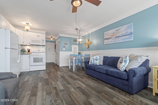 living room with a textured ceiling, ceiling fan with notable chandelier, ornamental molding, and dark wood-type flooring