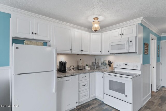 kitchen featuring white cabinets, dark wood-type flooring, and white appliances