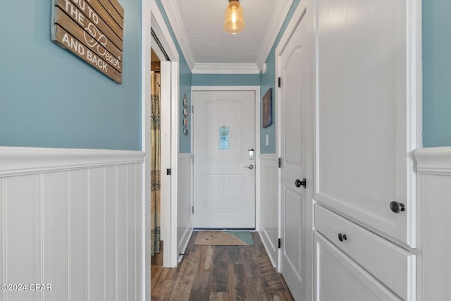 doorway featuring a textured ceiling, dark hardwood / wood-style floors, and ornamental molding