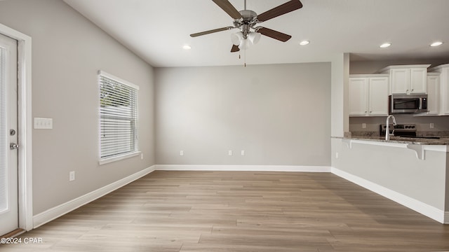 interior space featuring ceiling fan and light hardwood / wood-style flooring