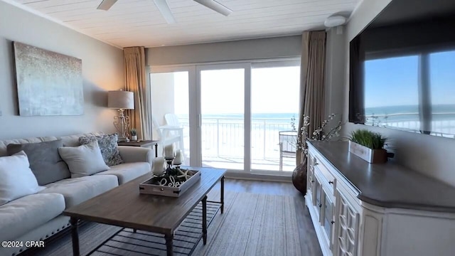 living room with ceiling fan, hardwood / wood-style floors, a water view, and wooden ceiling