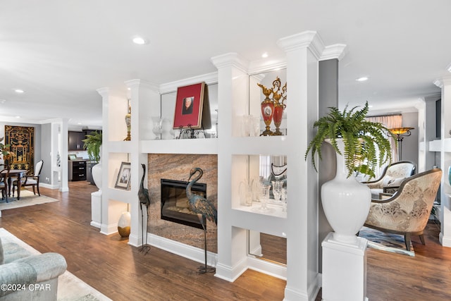 living room featuring ornate columns, ornamental molding, and dark hardwood / wood-style flooring