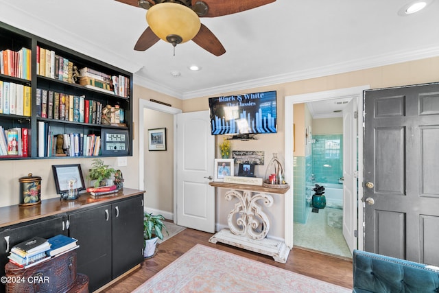 interior space with ceiling fan, hardwood / wood-style flooring, and crown molding