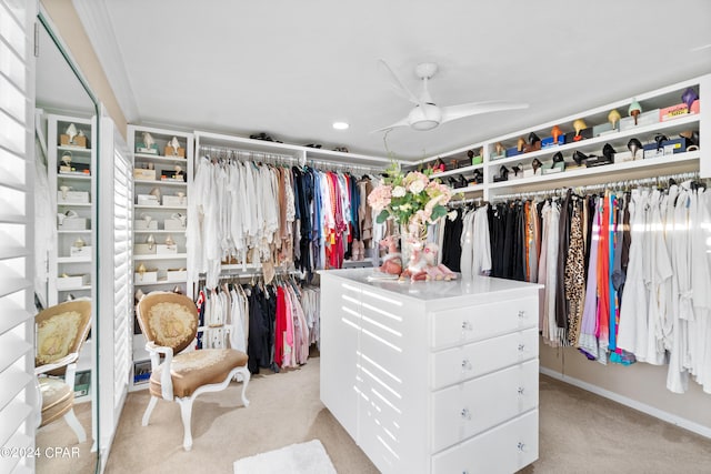 spacious closet featuring ceiling fan and light colored carpet