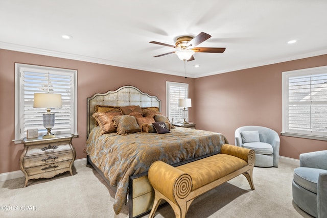 bedroom featuring multiple windows, ornamental molding, light carpet, and ceiling fan