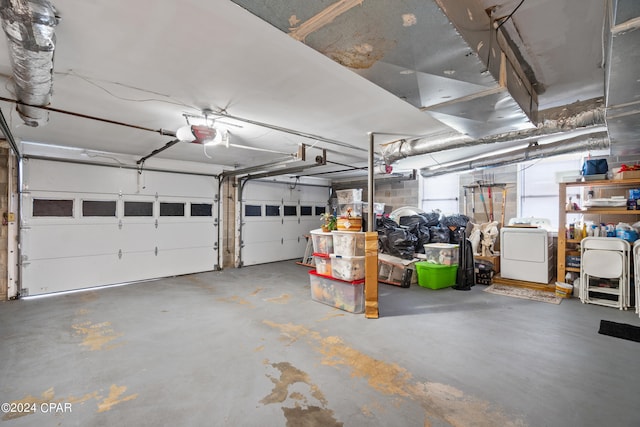 garage featuring a garage door opener and separate washer and dryer