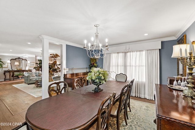 dining area featuring hardwood / wood-style flooring, crown molding, and a notable chandelier