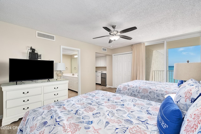 bedroom with ceiling fan, a textured ceiling, a closet, and ensuite bath