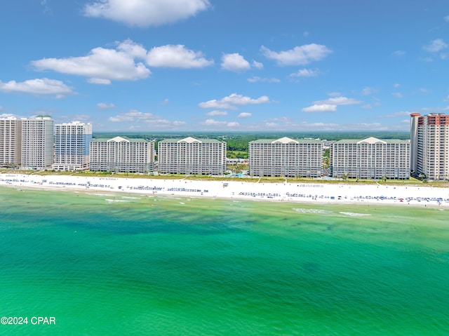 drone / aerial view featuring a beach view and a water view