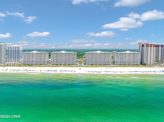 birds eye view of property featuring a beach view and a water view