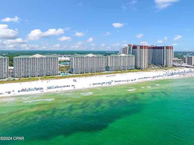 birds eye view of property featuring a water view and a beach view