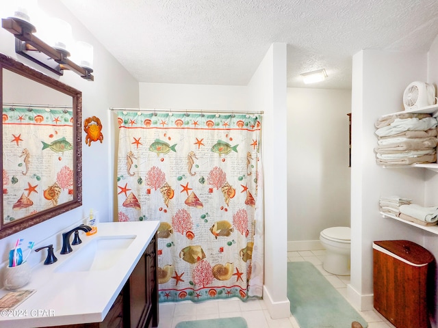 full bathroom with vanity, baseboards, tile patterned flooring, a textured ceiling, and toilet