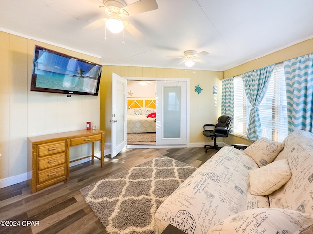 living room featuring baseboards, wood finished floors, and a ceiling fan