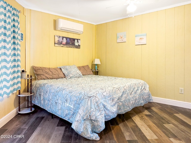 bedroom with an AC wall unit, ceiling fan, hardwood / wood-style floors, and crown molding