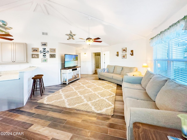 living area featuring visible vents, high vaulted ceiling, wood finished floors, and a ceiling fan