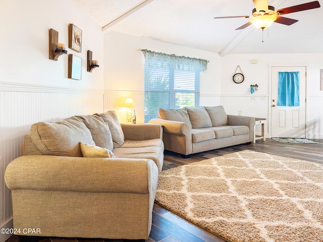 living room with lofted ceiling with beams, ceiling fan, and dark wood-type flooring