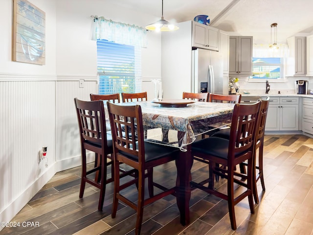 dining room with dark hardwood / wood-style floors and sink