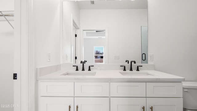 bathroom with vanity and toilet