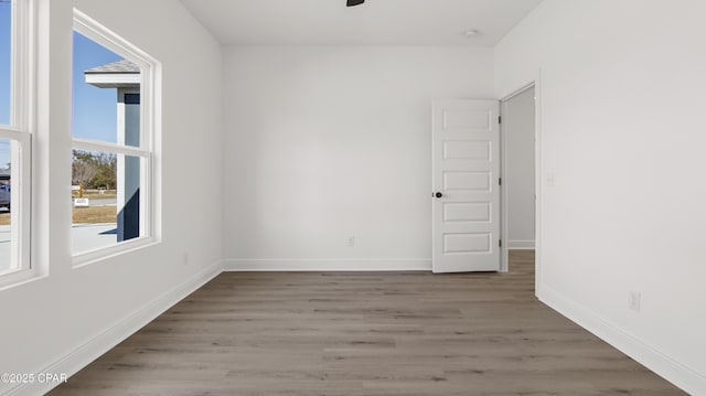 spare room featuring ceiling fan and hardwood / wood-style floors