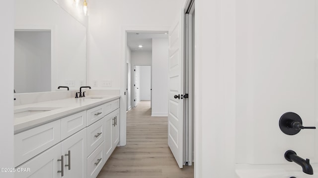 bathroom featuring vanity, hardwood / wood-style floors, and a shower