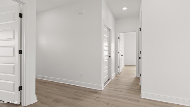 corridor with light hardwood / wood-style floors