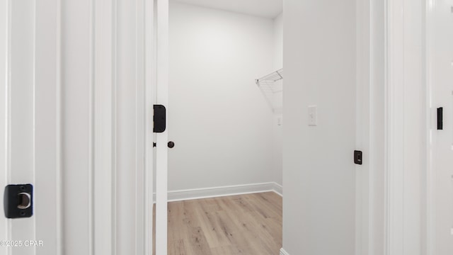 spacious closet with light hardwood / wood-style flooring