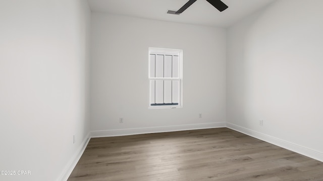 spare room featuring hardwood / wood-style flooring and ceiling fan