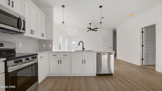 kitchen featuring white cabinets, light hardwood / wood-style floors, appliances with stainless steel finishes, and sink