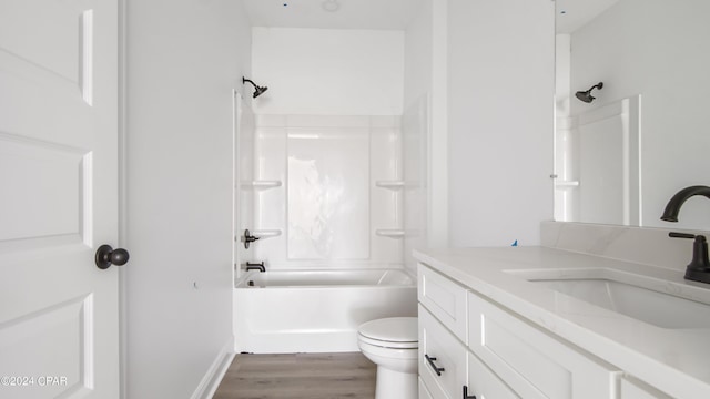 bathroom featuring vanity, bathtub / shower combination, wood finished floors, and toilet