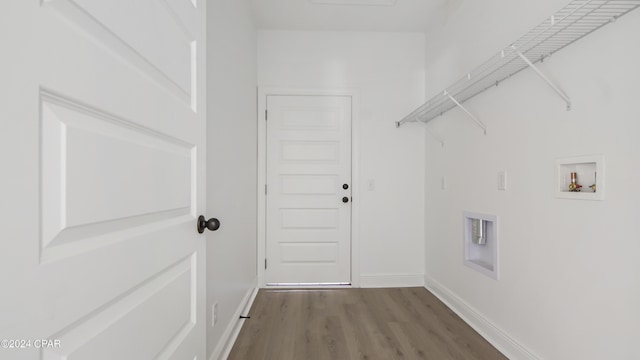 washroom with laundry area, hookup for a washing machine, baseboards, and wood finished floors