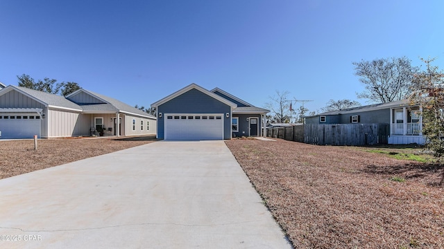 view of front of house with driveway, an attached garage, and fence