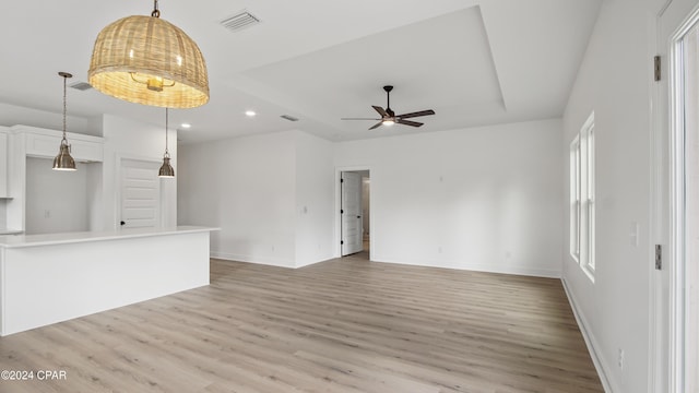 unfurnished living room featuring hardwood / wood-style floors, ceiling fan, and plenty of natural light