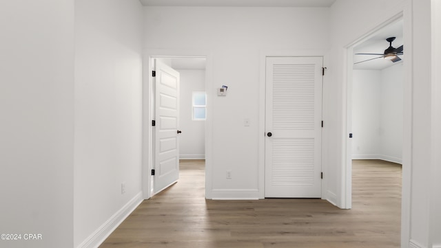 corridor with wood-type flooring