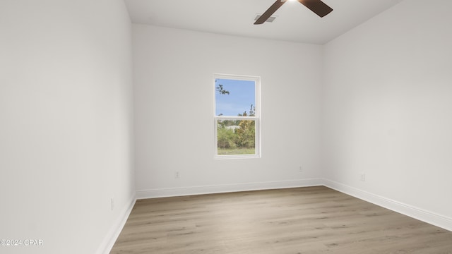 empty room with ceiling fan and light hardwood / wood-style flooring