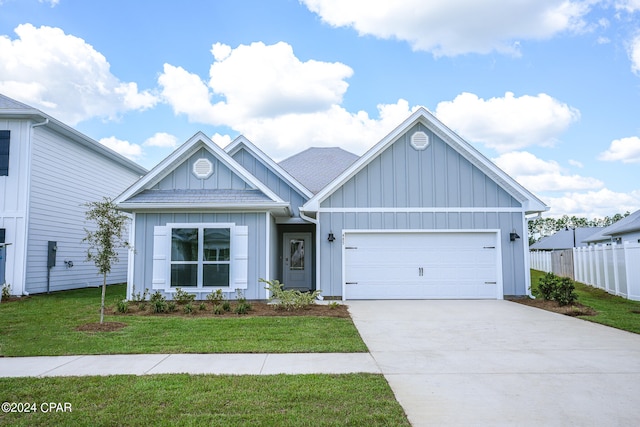 view of front of house with a garage and a front lawn