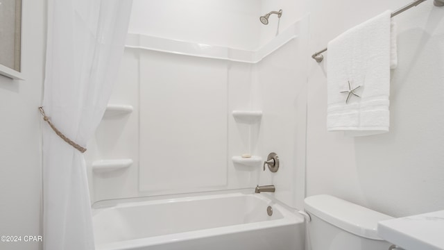 bathroom featuring shower / bath combination with curtain and toilet