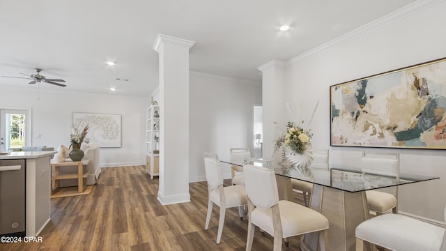 dining space featuring ornate columns, crown molding, ceiling fan, and dark wood-type flooring