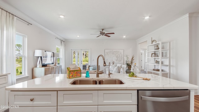 kitchen featuring a wealth of natural light, white cabinetry, and stainless steel dishwasher