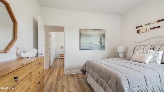 bedroom with dark hardwood / wood-style flooring