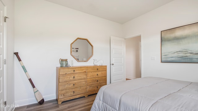 bedroom with dark wood-type flooring