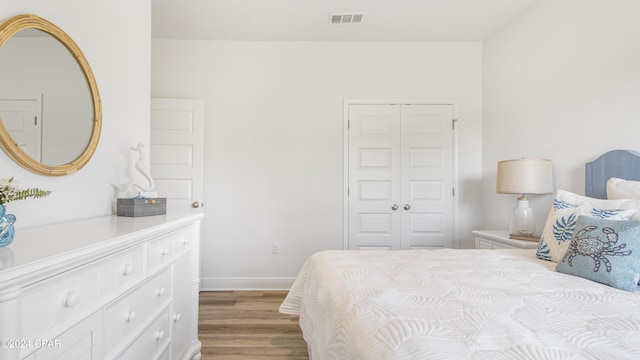 bedroom featuring a closet and light hardwood / wood-style flooring